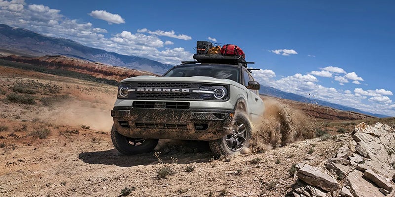 a brand new 2023 Bronco Sport having some off-roading fun in desert type terrain mountains.