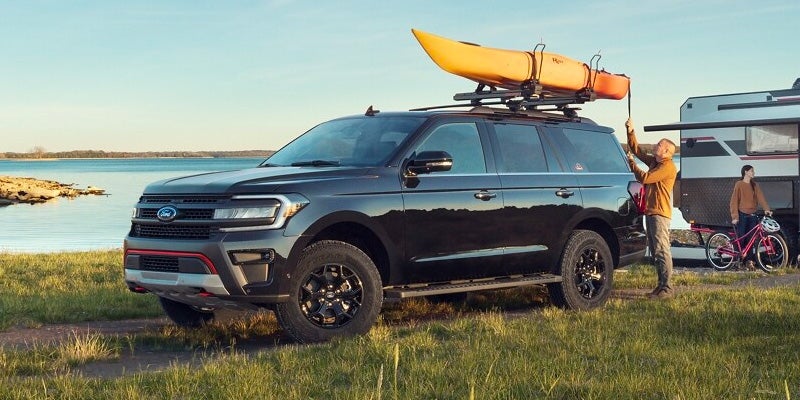 A family took out their brand new 2024 Ford Expedition travel trailer in tow with a kayak strapped to the roof racks.